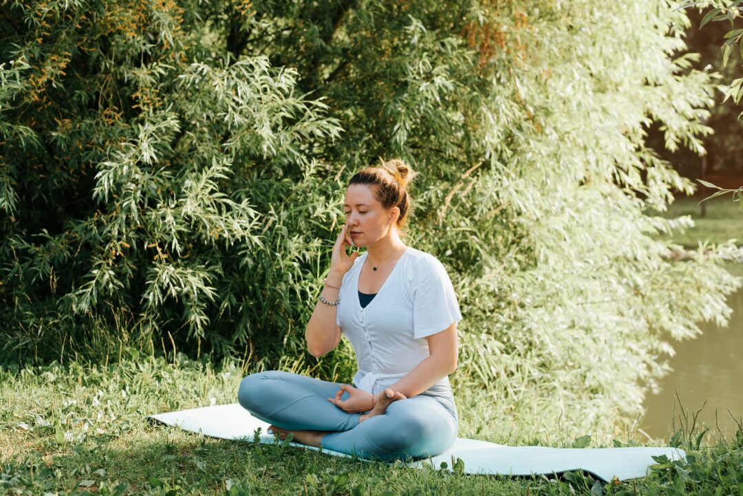 Breathing exercise, yoga and meditation practice. Caucasian young woman breathing with one nostril Atemübungen richtig Atmen